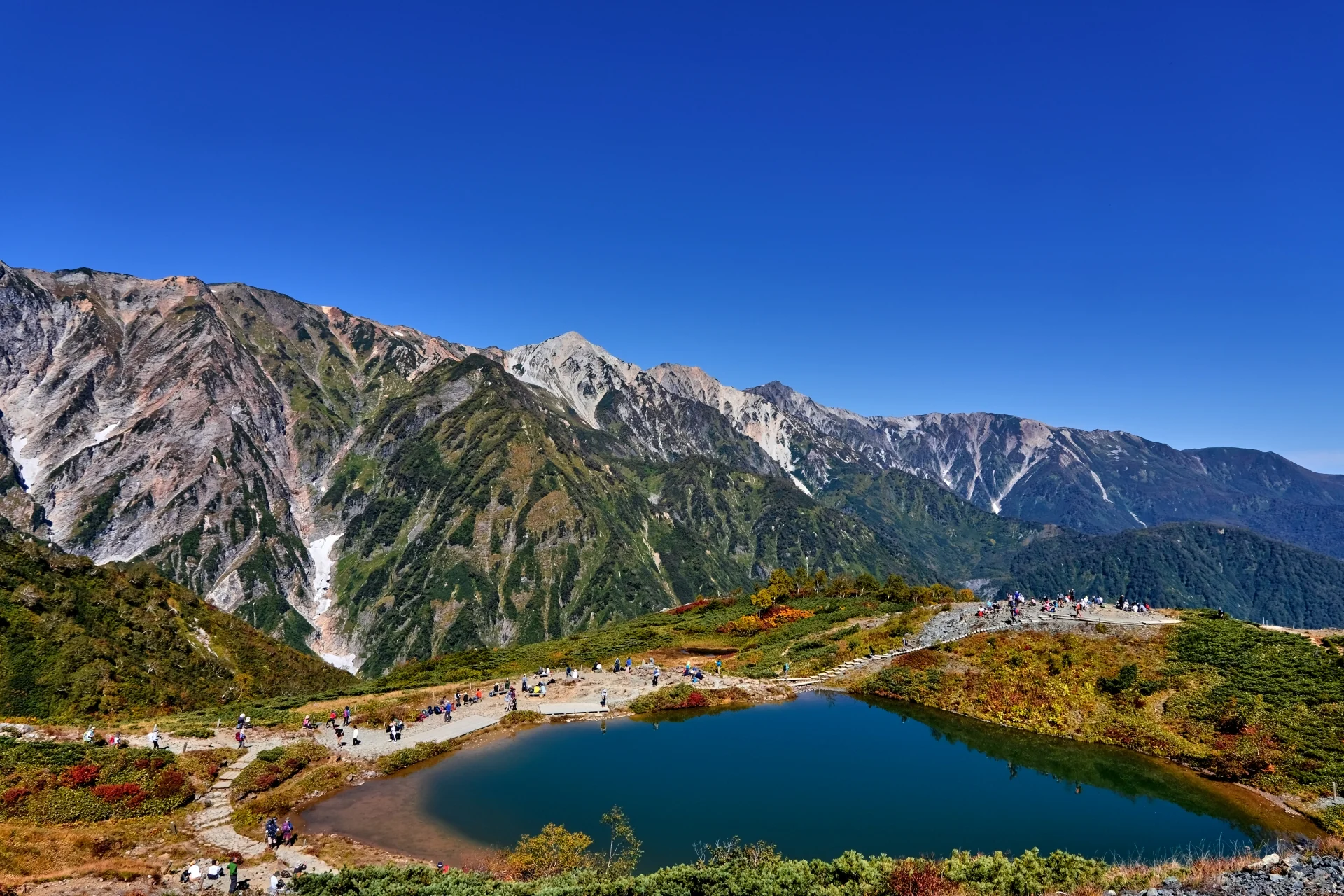 Happo Pond reflecting autumn foliage and Japan Alps